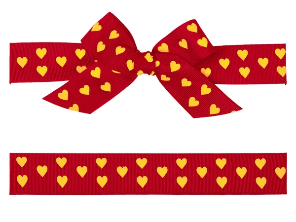 Red bow with yellow hearts and ribbon — Stock Photo, Image