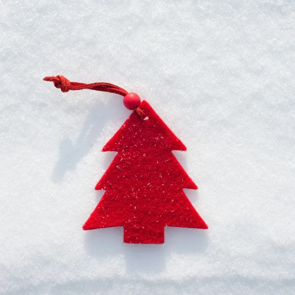 Plushy red fir tree toy on snow background — Stock Photo, Image