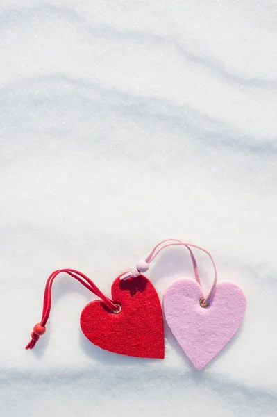 Two hearts on snow background — Stock Photo, Image