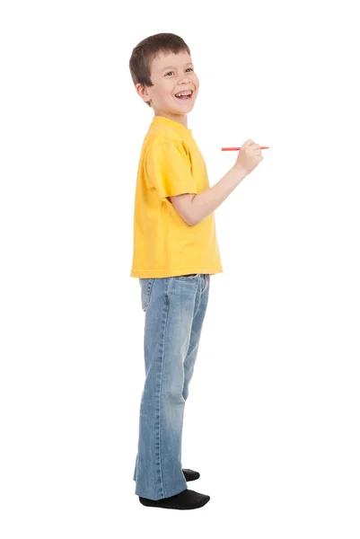 Chłopiec w żółty t-shirt pisze znacznik — Zdjęcie stockowe