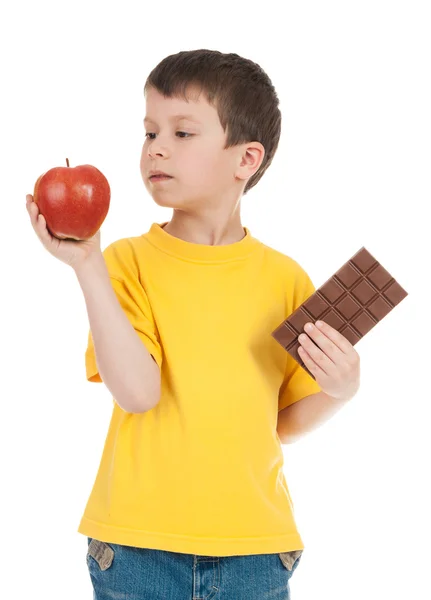 Boy with apple and chocolate — Stock Photo, Image