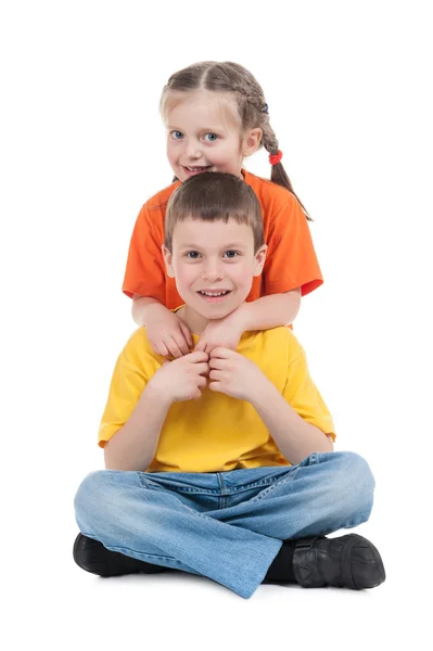 Lachende jongen en meisje op wit Stockfoto