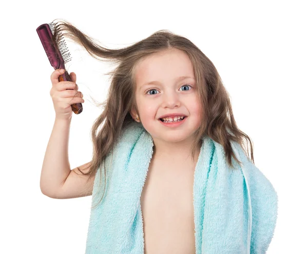 Girl combs her hair — Stock Photo, Image