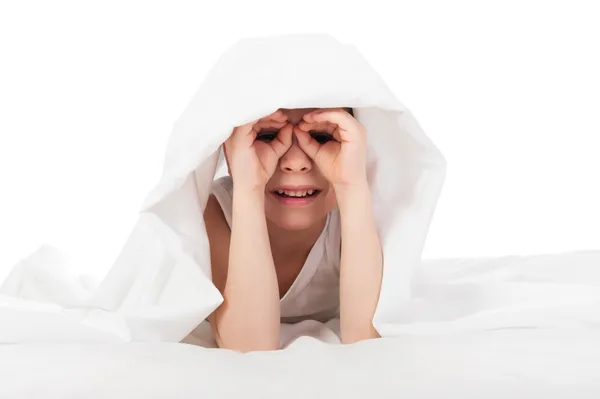 Cheerful boy hiding under blanket — Stock Photo, Image