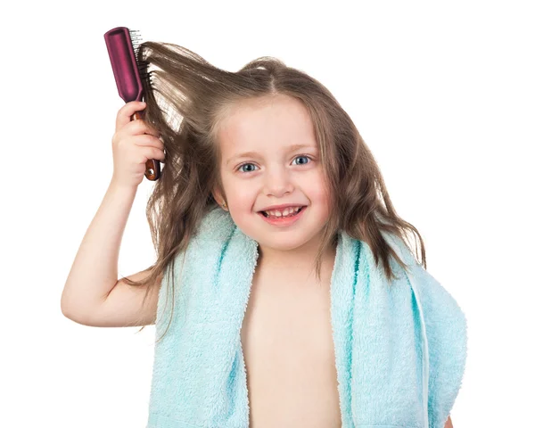 Girl combs her hair — Stock Photo, Image