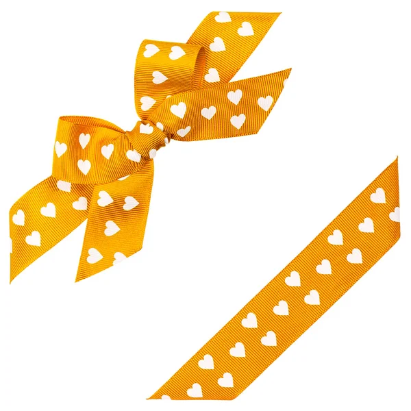 Yellow bow with hearts and ribbon — Stock Photo, Image