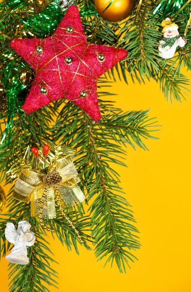 Christmas fir tree decoration on yellow — Stock Photo, Image