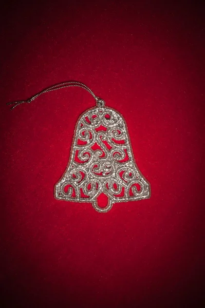 Christmas silver bell on red — Stock Photo, Image