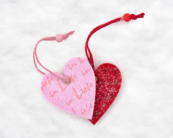 Two heart toys covered with snow Stock Image