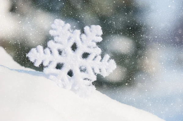 Big snowflake toy in snowdrift — Stock Photo, Image