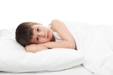 cheerful boy in white bed