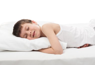 cheerful boy in white bed