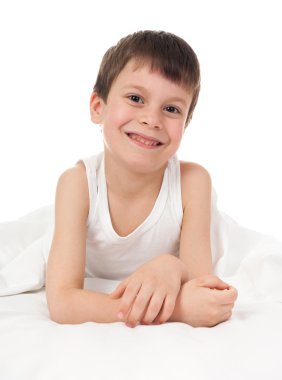 cheerful boy in white bed