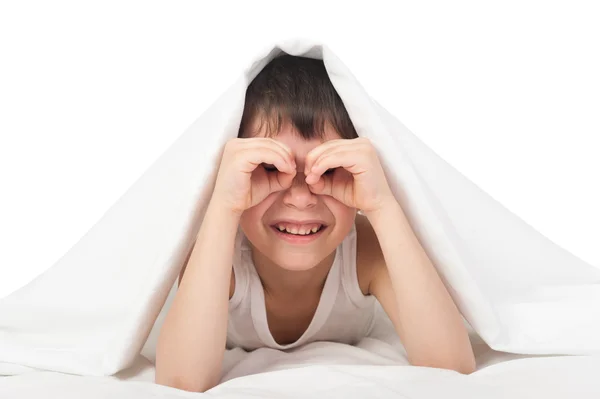 Boy under the blanket look through his palms like binoculars — Stock Photo, Image