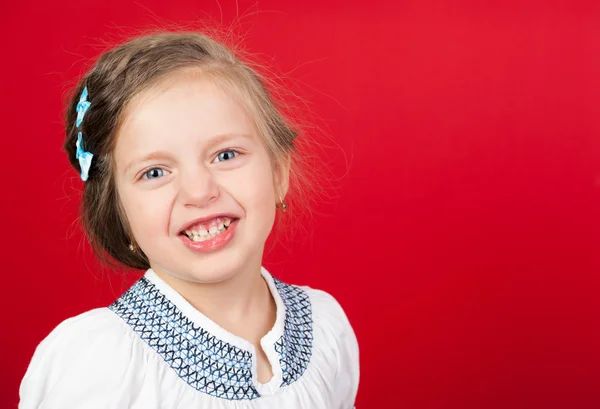 Smiling girl portrait on red — Stock Photo, Image