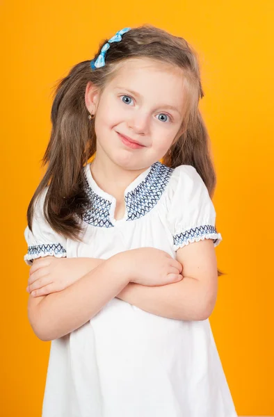 Smiling girl portrait on yellow — Stock Photo, Image