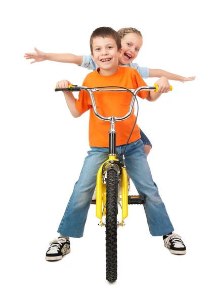 Garçon et fille sur vélo isolé sur blanc — Photo