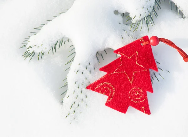 Red christmas tree toy in snow — Stock Photo, Image
