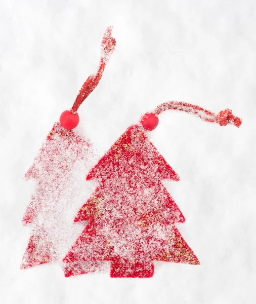 Red christmas tree toy in snow — Stock Photo, Image