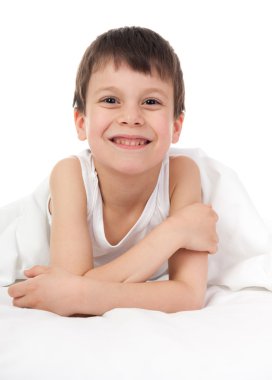 cheerful boy in white bed