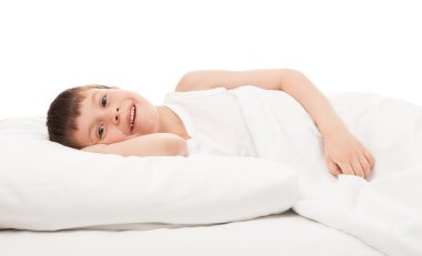 cheerful boy in white bed