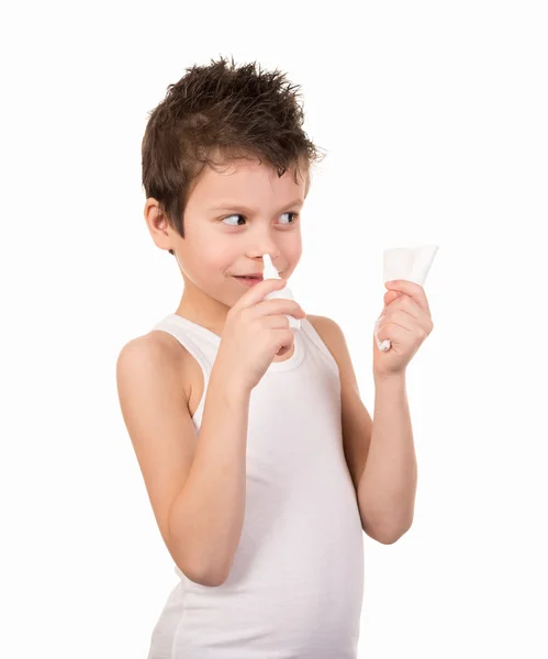 Boy boy uses a cold spray in white shirt — Stock Photo, Image