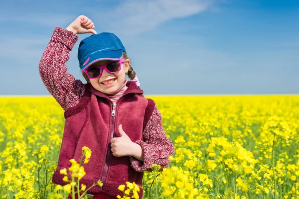 Girl in yellow field of rape — Stock Photo, Image