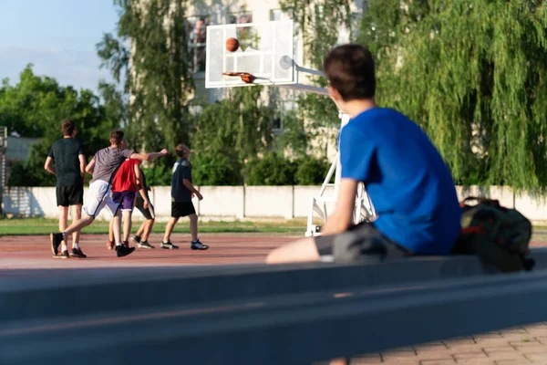 Killen Sitter Kanten Planen Och Tittar Basketmatch — Stockfoto