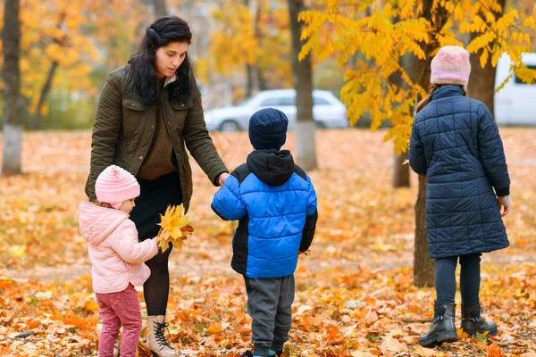 Dzieci Bawią Się Żółtymi Liśćmi Klonu Jesiennym Parku Miejskim Jesienny — Zdjęcie stockowe
