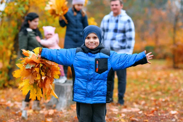在秋天的城市公园里 一个有孩子的家庭的画像 快乐的人们在树桩旁 美丽的大自然中 背景是黄叶 — 图库照片