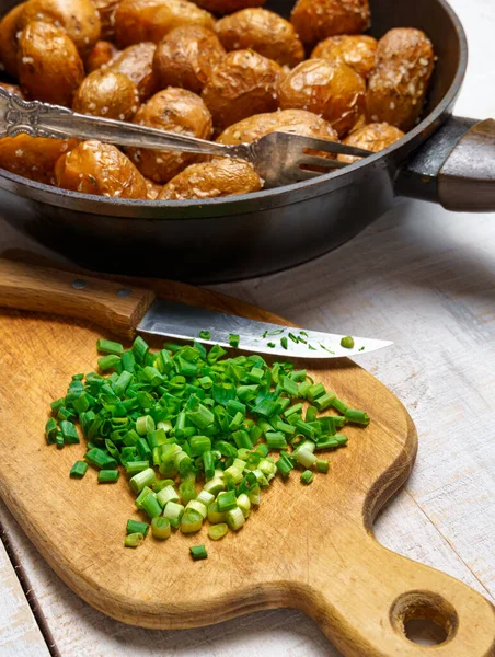 在平底锅中切碎青葱和炸土豆 在白色木板的背景中以乡村风格烹调食物 — 图库照片