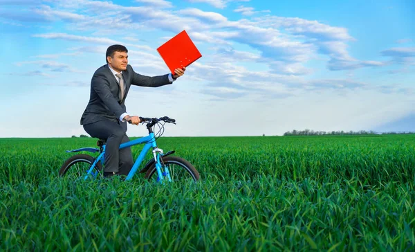 Businessman Red Folder Reports Documents Rides Bicycle Green Grass Field — Stock Photo, Image