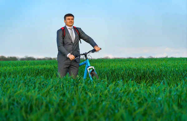Homem Negócios Posa Com Mochila Bicicleta Campo Grama Verde Vestida — Fotografia de Stock