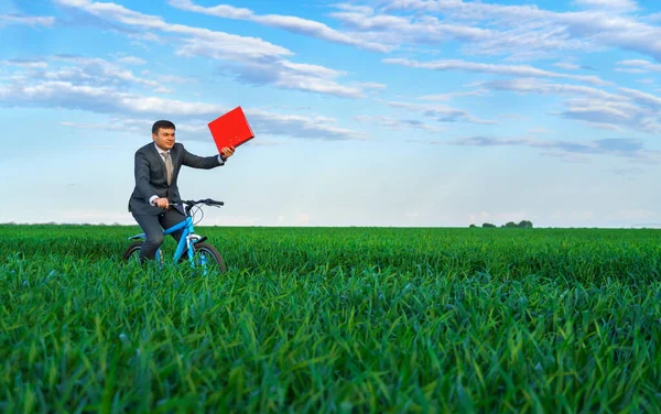 Businessman Red Folder Reports Documents Rides Bicycle Green Grass Field — Stock Photo, Image