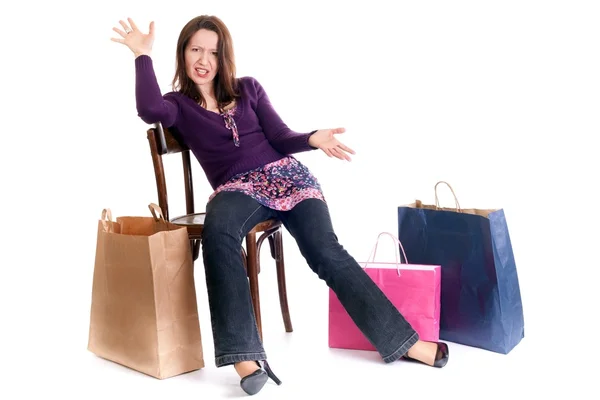 Woman sitting on a chair with packages — Stock Photo, Image