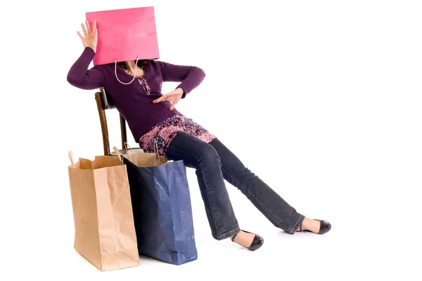 Woman sitting on a chair with packages — Stock Photo, Image