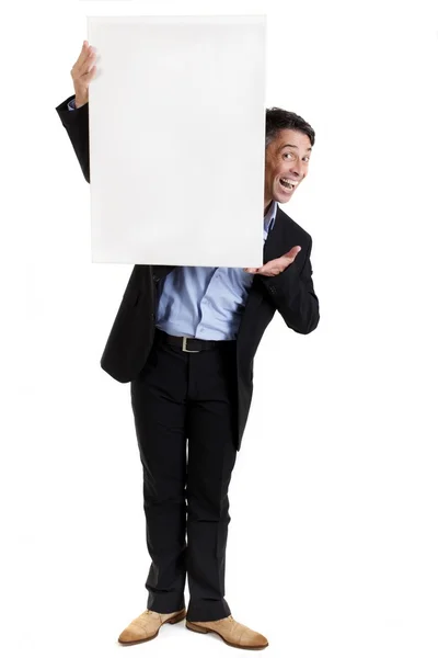 Businessman with a blank white sign — Stock Photo, Image