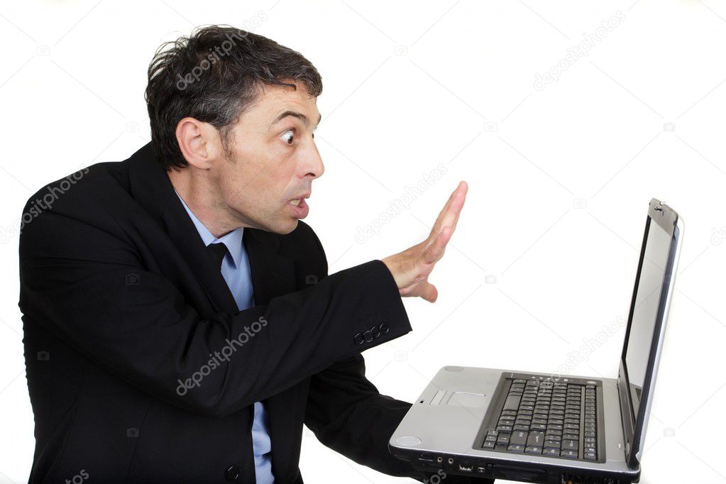 Businessman casting a spell on his laptop