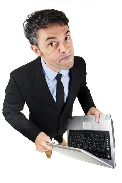 Pugnacious businessman holding a laptop — Stock Photo, Image