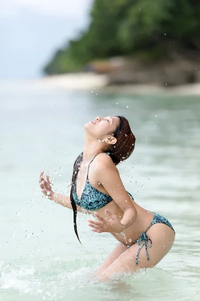 Junge filipina frau plantschen im meer — Stockfoto