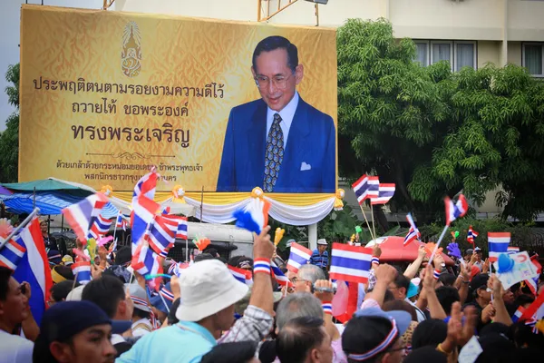 Manifestantes tailandeses pasan cartelera del rey Bhumibol — Foto de Stock