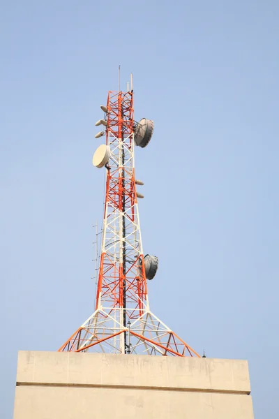 Telecom tower on top of building — Stock Photo, Image