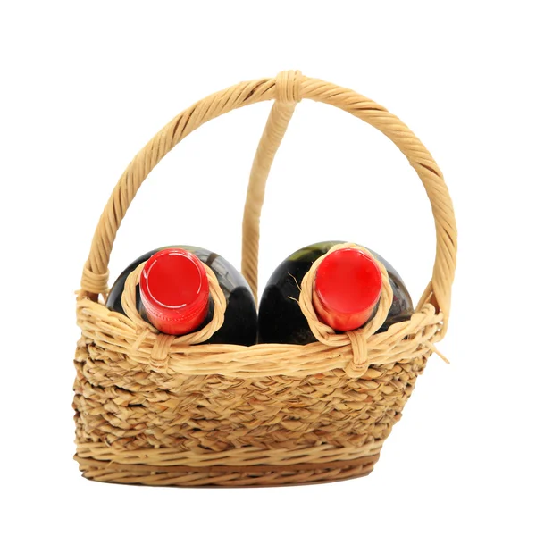 Two wine bottles on present basket isolated on white — Stock Photo, Image