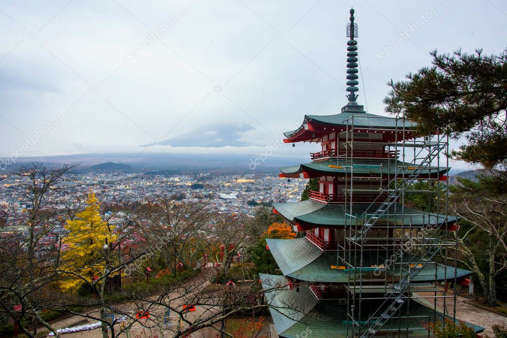 Chureito pagoda with heavy fog after sunset, fuji best mountain viewpoint, with colorful autumn foliage leaf in Shimoyoshida, Japan. Under fixing of tower.