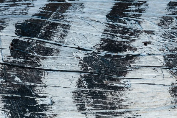 Black and white paint on cracked wood. pastel wood planks textured background.