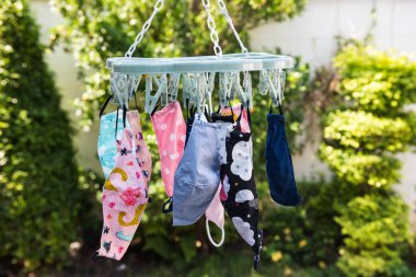 Reuse kid face masks hang to dry by sun light after washing