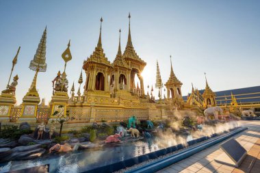 Golden Royal Cremation with elephant statues against sunbeam of His Majesty, The Late King Bhumibol Adulyadej, Rama 9, In Remembrance during sunset at Sanam Luang, Bangkok, Thailand
