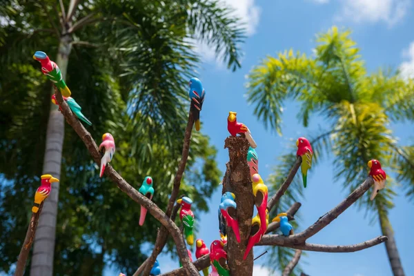 Fake Colorful Parrot Birds Decorated Tree Blur Foliage Bokeh Blue — Stockfoto