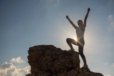 Silhouette athlete hiker raise 2 hands for victory hand gesture
