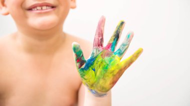 Colorful paint hand of blur smiling boy isolated on white background. Art work concept.